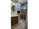 Bathroom featuring a shower with glass doors, vanity, neutral walls, and tiled flooring at 2505 Minnehaha, Tampa, FL 33614