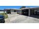 Exterior view of the home showcasing a carport and driveway with a car parked underneath at 2505 Minnehaha, Tampa, FL 33614