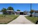 Inviting single-story home with a long driveway leading to a covered carport and manicured lawn at 2505 Minnehaha, Tampa, FL 33614