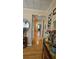 Hallway featuring hardwood floors, decorated walls, and access to multiple rooms at 2505 Minnehaha, Tampa, FL 33614