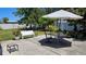 Patio with outdoor seating and umbrella, perfect for enjoying the backyard on a sunny day at 2505 Minnehaha, Tampa, FL 33614