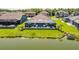 Aerial view of home showing backyard with screened-in patio, lake and lush green grass at 28857 Picana Ln, Wesley Chapel, FL 33543