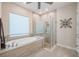 Luxurious bathroom with a soaking tub, glass shower, and stylish tile work creating a relaxing retreat at 28857 Picana Ln, Wesley Chapel, FL 33543