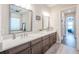 Elegant bathroom featuring double sinks, sleek cabinetry, and modern fixtures for a spa-like experience at 28857 Picana Ln, Wesley Chapel, FL 33543