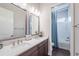 Bright bathroom featuring double sinks and a separate toilet area at 28857 Picana Ln, Wesley Chapel, FL 33543