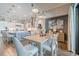 Bright dining area open to the kitchen, with modern decor and view to outdoor patio and pool at 28857 Picana Ln, Wesley Chapel, FL 33543