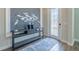 Inviting foyer features decorative table, art piece, and elegant door at 28857 Picana Ln, Wesley Chapel, FL 33543