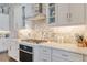 Well-lit kitchen featuring modern appliances, white cabinets, and tiled backsplash at 28857 Picana Ln, Wesley Chapel, FL 33543
