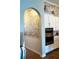 Kitchen featuring stylish brick accent wall, modern appliances and white cabinetry at 28857 Picana Ln, Wesley Chapel, FL 33543