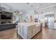 Bright kitchen island with sink, stainless steel appliances, with open view to the living room at 28857 Picana Ln, Wesley Chapel, FL 33543