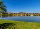 Picturesque lake view with lush green lawn, offering tranquility and beauty at 28857 Picana Ln, Wesley Chapel, FL 33543