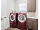 Functional laundry room featuring a sink, ample storage, and modern appliances for convenient chores at 28857 Picana Ln, Wesley Chapel, FL 33543