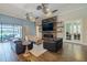 Cozy living room with sliding glass doors to outdoor area, fireplace and ceiling fans at 28857 Picana Ln, Wesley Chapel, FL 33543