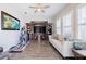 Spacious living room featuring wood floors, ceiling fan, entertainment center, and comfortable seating at 28857 Picana Ln, Wesley Chapel, FL 33543