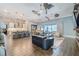 Open-concept living room with a kitchen island, dining area, and sliding doors to the outdoors at 28857 Picana Ln, Wesley Chapel, FL 33543