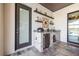 Outdoor kitchen with stone counter, beverage cooler, and grill, perfect for entertaining at 28857 Picana Ln, Wesley Chapel, FL 33543