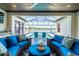 Outdoor patio with comfortable seating overlooking a pool and lake at 28857 Picana Ln, Wesley Chapel, FL 33543