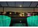 Picturesque night view of the lake from this pool with soothing lounge chairs and starlit sky at 28857 Picana Ln, Wesley Chapel, FL 33543