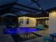 Poolside paradise with ambient lighting, multiple lounge chairs, and cascading water features at 28857 Picana Ln, Wesley Chapel, FL 33543