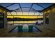 Gorgeous covered lanai pool featuring two Adirondack chairs offering lake view and evening ambiance at 28857 Picana Ln, Wesley Chapel, FL 33543