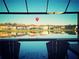 Relaxing poolside view of a calm lake and neighborhood homes under a hot air balloon at 28857 Picana Ln, Wesley Chapel, FL 33543