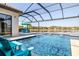Beautiful swimming pool with lake views, sun chairs, and a screened enclosure at 28857 Picana Ln, Wesley Chapel, FL 33543