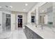 Luxurious bathroom with double vanity, marble accents, walk-in closet at 2947 Cedar Trce, Tarpon Springs, FL 34688
