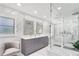 Modern bathroom featuring marble walls, dual vanity, frameless shower, and stylish fixtures at 2947 Cedar Trce, Tarpon Springs, FL 34688