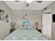 Comfortable bedroom with decorative pillows, ambient lamps, floral artwork, and a ceiling fan at 2947 Cedar Trce, Tarpon Springs, FL 34688