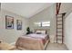 Cozy bedroom with a sloped ceiling, ladder access, and a sunny window enhancing the calming ambiance at 2947 Cedar Trce, Tarpon Springs, FL 34688