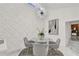 Bright dining room showcasing a modern chandelier and textured accent wall at 2947 Cedar Trce, Tarpon Springs, FL 34688