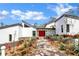 Contemporary home with a bold red door, geometric landscaping, and modern architectural design at 2947 Cedar Trce, Tarpon Springs, FL 34688