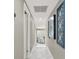 Bright hallway with marble tile floors and decorative wall art at 2947 Cedar Trce, Tarpon Springs, FL 34688