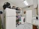 This laundry room has marble floors, a washer and dryer, and an adjacent freezer at 2947 Cedar Trce, Tarpon Springs, FL 34688