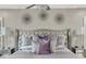 A stylish main bedroom features a tufted headboard, decorative pillows, and elegant nightstands with crystal lamps at 2947 Cedar Trce, Tarpon Springs, FL 34688
