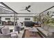 This patio has a ceiling fan, a hot tub, an outdoor dining table, and nice furniture at 2947 Cedar Trce, Tarpon Springs, FL 34688