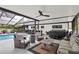 Outdoor living space with a pool, spa, and cozy seating areas, perfect for relaxation and entertaining at 2947 Cedar Trce, Tarpon Springs, FL 34688