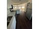Modern kitchen with stainless appliances, white cabinets, and an island that overlooks an open living space at 321 David Ave, Clearwater, FL 33759