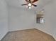 Bright and airy bedroom features neutral carpeting, ceiling fan, and natural light at 329 Seneca Falls Dr, Apollo Beach, FL 33572