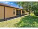 Backyard featuring an enclosed patio with screens and landscaped lawn and garden at 329 Seneca Falls Dr, Apollo Beach, FL 33572