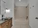 Stylish bathroom featuring a unique stone sink and shower-over-tub with neutral tile surround at 329 Seneca Falls Dr, Apollo Beach, FL 33572
