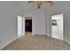 Bedroom with ceiling fan and doorways to en-suite bath and walk-in closet at 329 Seneca Falls Dr, Apollo Beach, FL 33572