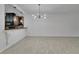 Open-concept dining room with modern chandelier and breakfast bar overlooking the kitchen at 329 Seneca Falls Dr, Apollo Beach, FL 33572