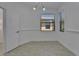 Well-lit dining room with tiled floor, window with blinds, and entry to hall at 329 Seneca Falls Dr, Apollo Beach, FL 33572