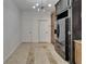 Kitchen with custom cabinets, black refrigerator, and tile floor leading to hallway at 329 Seneca Falls Dr, Apollo Beach, FL 33572