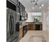 Open kitchen with black appliances, mosaic backsplash, custom cabinets, and tile flooring at 329 Seneca Falls Dr, Apollo Beach, FL 33572