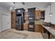 Kitchen featuring custom wood cabinets, black appliances, and tile backsplash at 329 Seneca Falls Dr, Apollo Beach, FL 33572