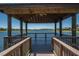 Scenic lake view from a charming wooden gazebo, offering a tranquil space to relax and enjoy the natural surroundings at 329 Seneca Falls Dr, Apollo Beach, FL 33572