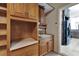 Convenient laundry room with wooden cabinetry, sink and access to the kitchen at 329 Seneca Falls Dr, Apollo Beach, FL 33572