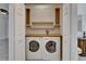 A laundry room features a washer, dryer, and storage cabinets with wood countertop at 329 Seneca Falls Dr, Apollo Beach, FL 33572